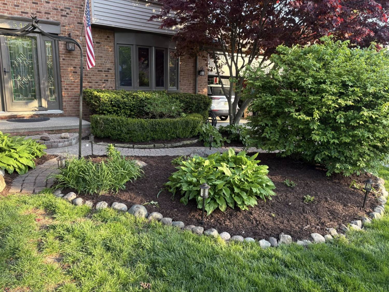 Manicured front yard garden beds by Alfie's Lawn Care Rochester Hills